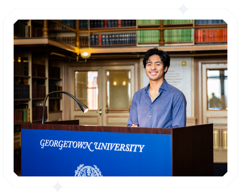 a headshot of michael standing behind a podium that says georgetown university